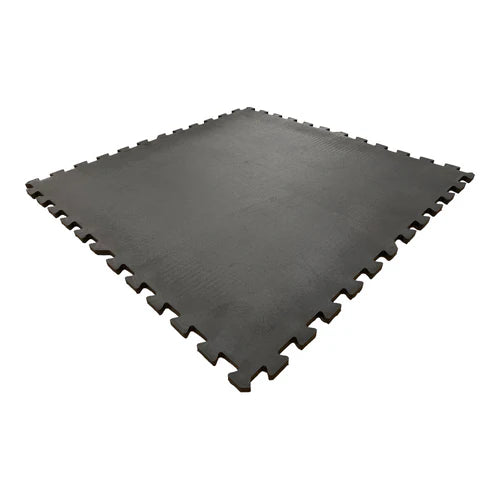 Interlocking black rubber gym floor tiles with a textured surface