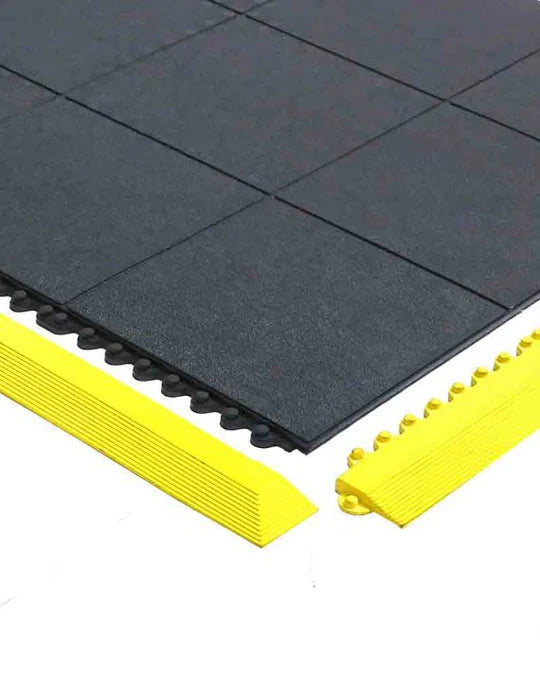 Interlocking rubber gym mats in black with yellow interlocking edges, designed for fitness equipment and workouts.
