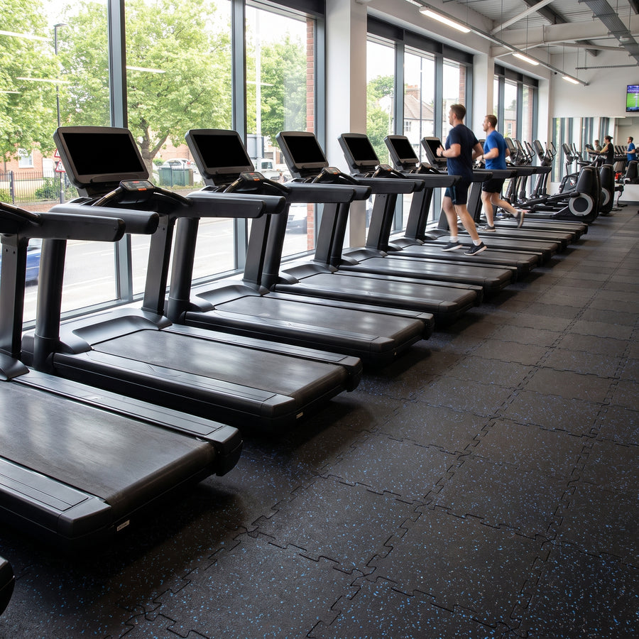 12mm blue fleck rubber gym tiles in a commercial gym cardio area under a row of treadmills